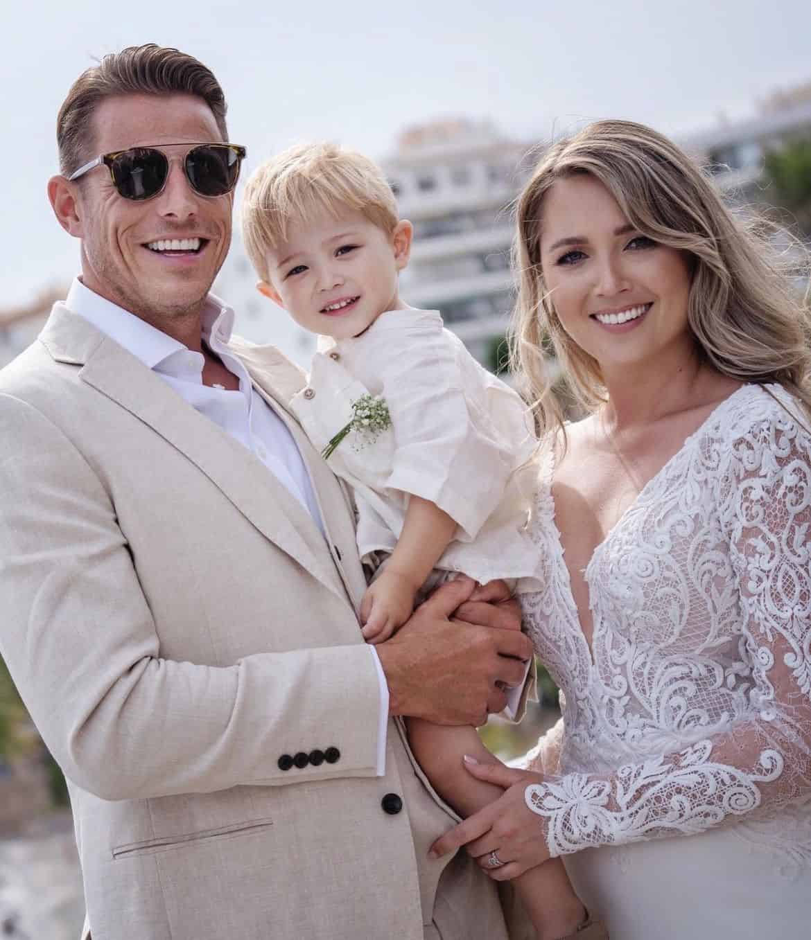 Elegant family dressed in bespoke suits and wedding attire outdoors.